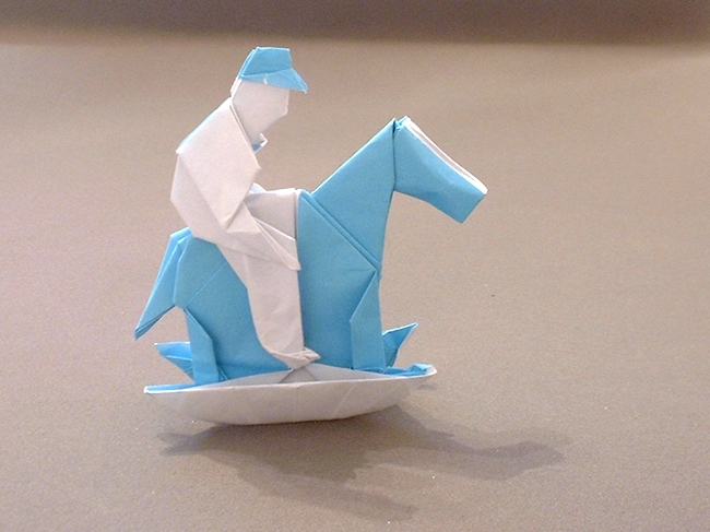 Origami Boy on a rocking horse by Neal Elias folded by Gilad Aharoni